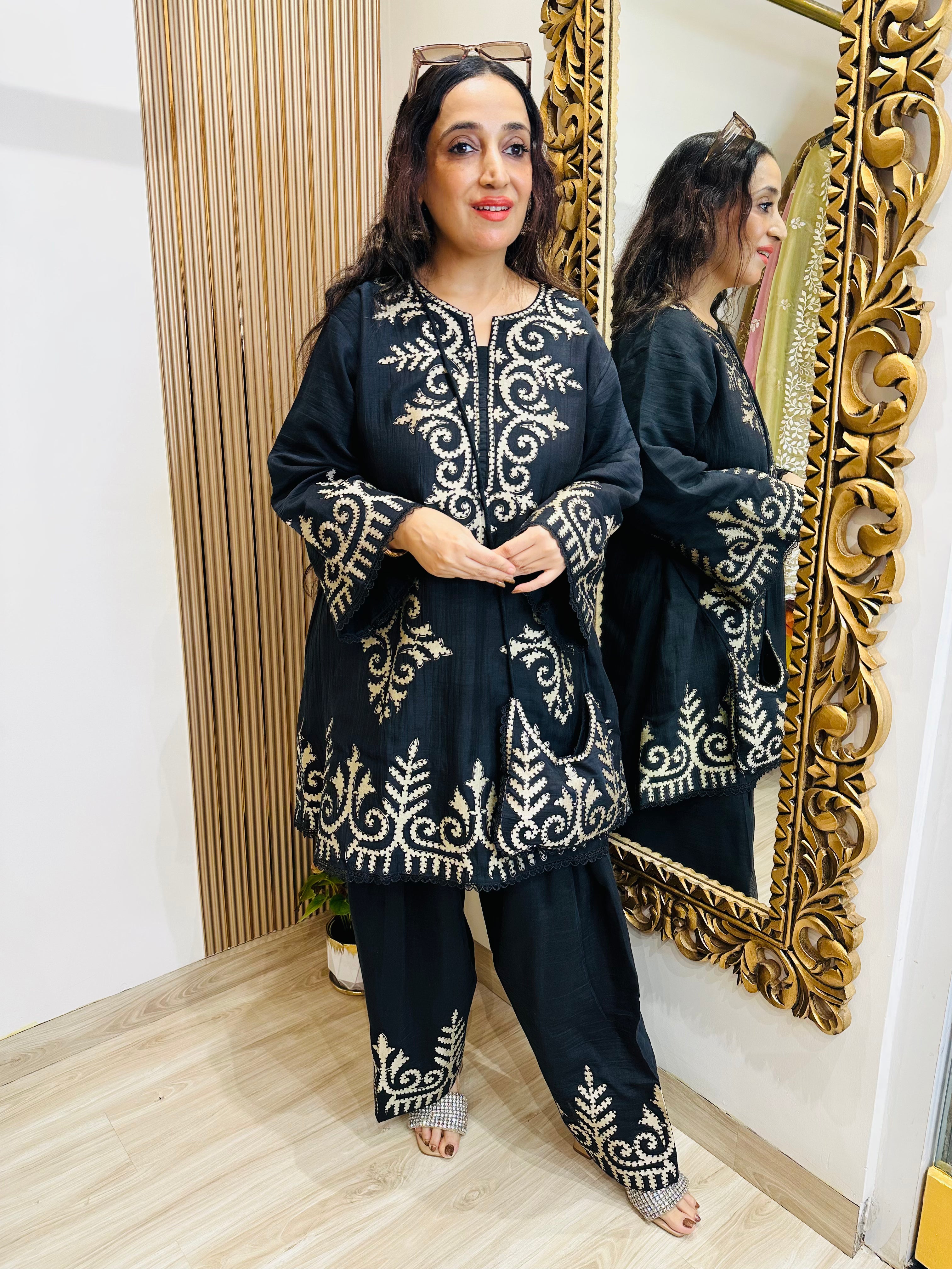 STITCHED PURE MULMUL CHANDERI KASHMIRI WORK INSPIRED CHOGA SETS WITH FARSHI SALWAR AND EMBROIDERED BAGS.