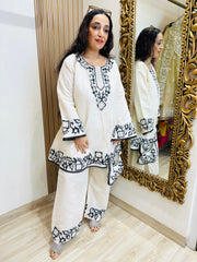 STITCHED PURE MULMUL CHANDERI KASHMIRI WORK INSPIRED CHOGA SETS WITH FARSHI SALWAR AND EMBROIDERED BAGS.